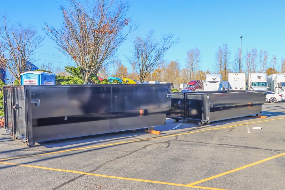 Professional dumpster rental service with roll-off container on residential driveway in Elsmere